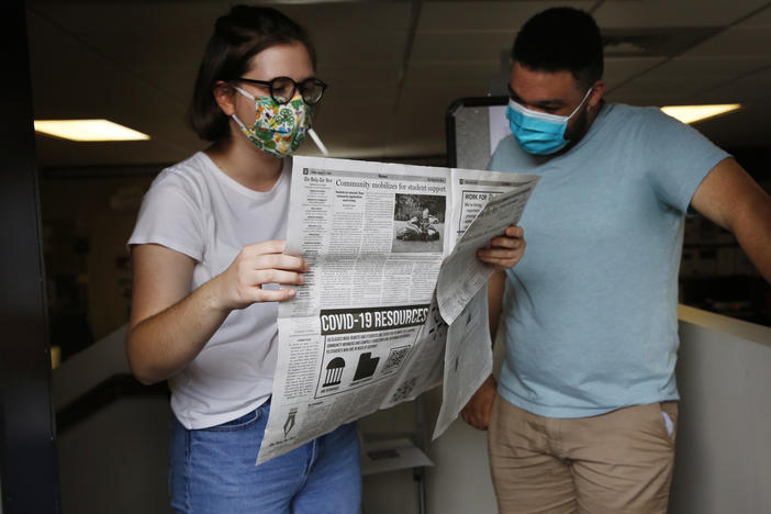 Student journalists Anna Pogarcic and Brandon Standley of UNC's <em>Daily Tar Heel</em> review a recent issue at their offices off campus.