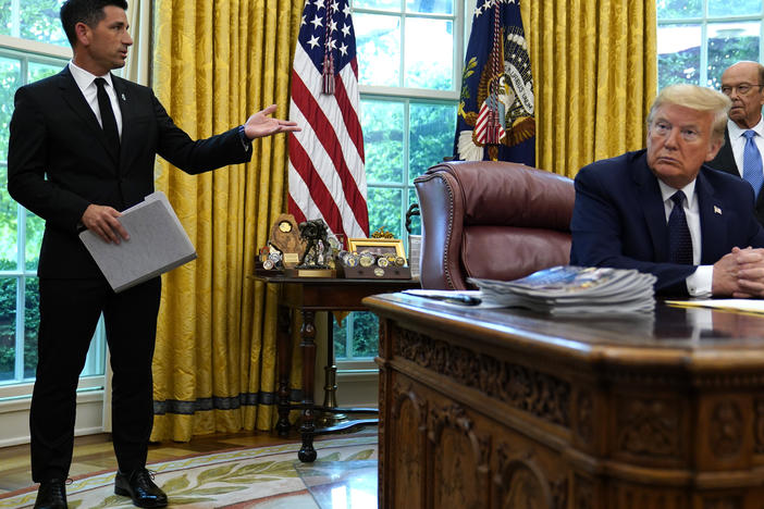 President Trump listens to acting Homeland Security Secretary Chad Wolf during a May briefing. Trump announced on Twitter he was nominating Wolf as DHS chief, but it's unclear if the GOP-controlled Senate will vote to confirm him.