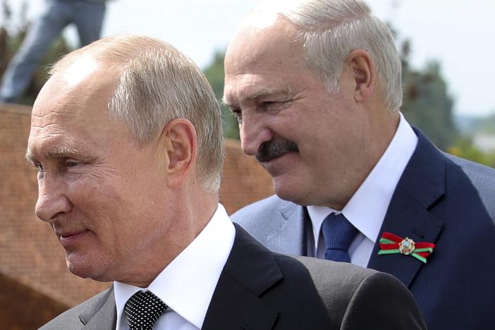 Russian President Vladimir Putin and Belarusian President Alexander Lukashenko greet a group of World War II veterans in the Russian village of Khoroshevo on June 30.
