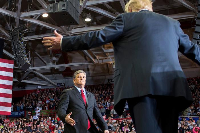 President Trump greets talk show host Sean Hannity at a 2018 rally in Cape Girardeau, Mo.