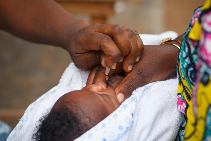 An oral polio vaccine, which contains weakened live virus, is administered in a health enter in Togo. Africa has declared that wild polio has been eradicated, but a relatively small number of cases of vaccine-derived polio persist.