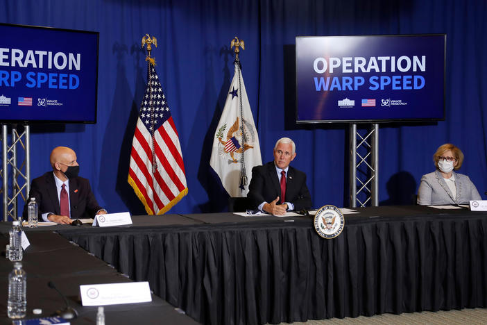 FDA Commissioner Stephen Hahn (left), Vice President Mike Pence, and Dr. Ella Grach, CEO of Wake Research, at the NC Biotechnology Center in July, where Phase 3 trials for a coronavirus vaccine candidate are underway.