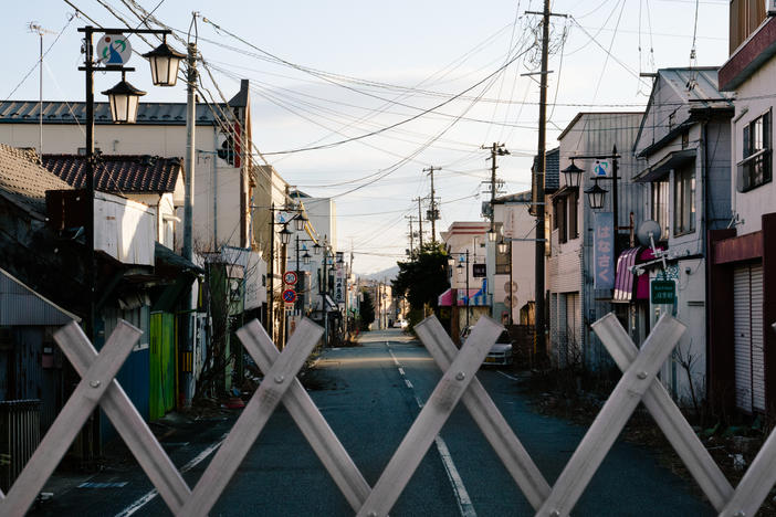 A view over a gate blocking off the old downtown of Okuma, in Fukushima Prefecture. Fukushima was forever changed by one of the world's biggest nuclear disasters nearly a decade ago.