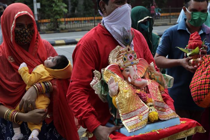 Devotees prepare to immerse in an artificial pond an idol of elephant-headed Hindu god Ganesh in Mumbai, India, Aug. 23. India's coronavirus caseload topped 3 million that day, with the country leading the world in new daily infections.