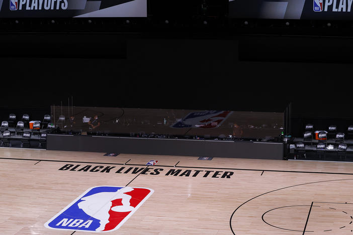 An empty court and bench are shown with no signage following the scheduled start time of Wednesday's NBA playoff series. NBA players made their strongest statement yet against racial injustice Wednesday when the Milwaukee Bucks didn't take the floor for their game against the Orlando Magic.