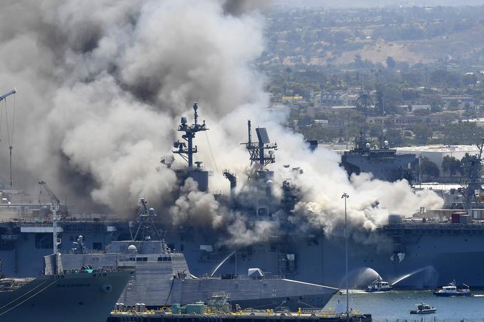 Smoke rises from the USS Bonhomme Richard after an explosion and fire on board the amphibious assault ship at Naval Base San Diego. The Navy is investigating whether the fire was due to arson.