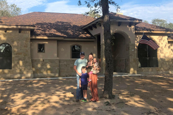 Caroline Wells and her family at their new home outside San Antonio. The builders just finished it so the yard has yet to be planted, but the couple are looking forward to letting the kids run out their energy with a lot more outdoor space than they had at their home in the city.