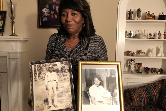Deloris Melton Gresham in her home in Drew, Miss., holding photographs of her parents Clinton and Beulah Melton.