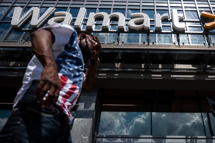 A man walks past a Walmart store in Washington, D.C. on July 15. Walmart said it was "confident" that its joint deal with Microsoft would satisfy both TikTok users and U.S. government regulators.