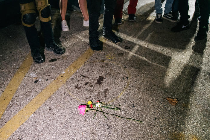 Demonstrators revisit the site where a protester was killed in Kenosha, Wis. On Aug. 25, 17-year-old Kyle Rittenhouse shot and killed two protesters. He was charged on Thursday with six criminal counts, including first-degree intentional homicide.