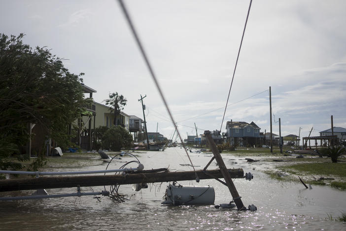 Damaged homes sit among floodwaters after Hurricane Laura passed through the area Thursday in Holly Beach, La.