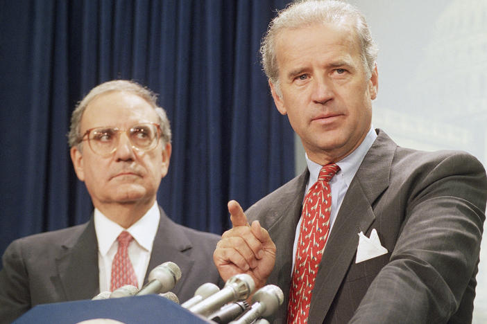 Then-Sen. Joe Biden (right) speaks at a Capitol Hill news conference in 1994 after the Senate voted on a major crime bill.