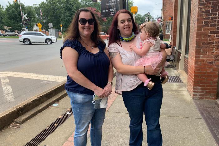 Grandmother Cindy Carroll, daughter Lauren Harrah and 11-month-old granddaughter Austin are headed to a local antique store in the historic district of Waxhaw, N.C. Carroll and Harrah aren't totally sold on President Trump, but they will vote for him over Joe Biden.