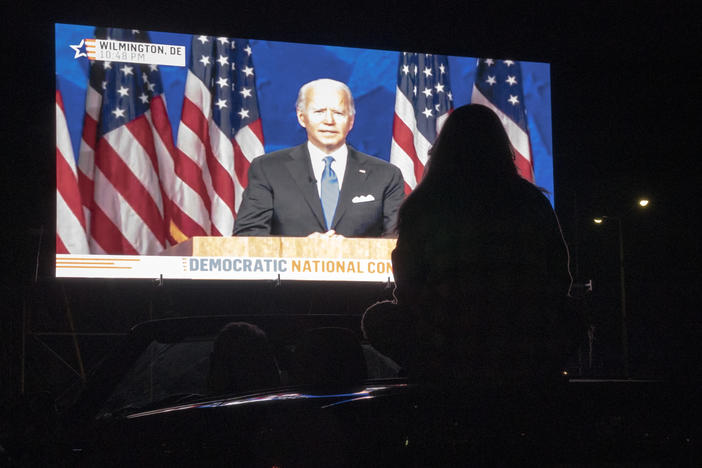 Members of the District of Columbia Democratic Party attend a drive-in watch party in the parking lot of the Robert F. Kennedy Memorial Stadium to watch Democratic presidential nominee Joe Biden accept the Democratic nomination for president on the final night of the Democratic National Convention on August 20, 2020.