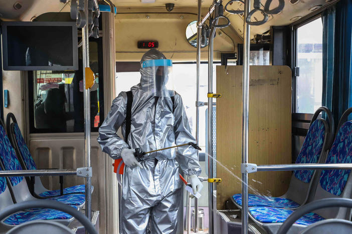 A worker disinfects the inside of a bus in Addis Ababa, Ethiopia. Transit agencies are taking new steps to reduce the risks for riders during the pandemic.