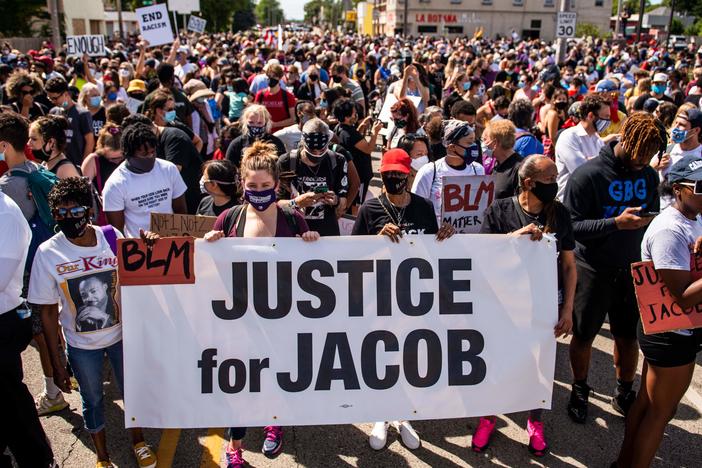 Protesters march with the family of Jacob Blake during a rally against racism and police brutality in Kenosha, Wisconsin, on August 29, 2020.