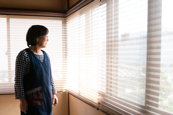 Tomoko stands at the inn in Fukushima prefecture that has been in her family for generations.