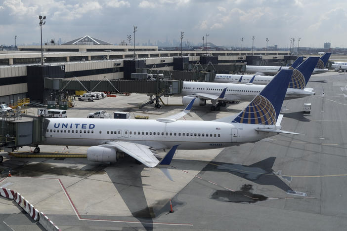 United Airlines planes are parked at gates last month at Newark Liberty International Airport in New Jersey. The airline announced it is eliminating many change fees, and Delta Air Lines and American Airlines quickly followed.