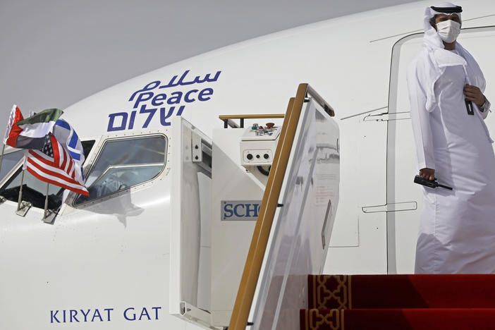 An official stands at the door of an Israeli El Al airliner after it landed in Abu Dhabi, United Arab Emirates, on Monday after flying in from Tel Aviv.