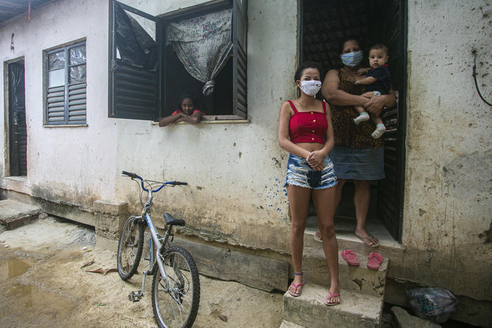 Flaviane da Conceição, 40, a self-employed house cleaner, poses for a photo at her home in the Cidade de Deus favela on July 29 in Rio de Janeiro, Brazil. A single mother of three, she applied for government emergency aid at the beginning of the coronavirus pandemic and it helps her support her family.