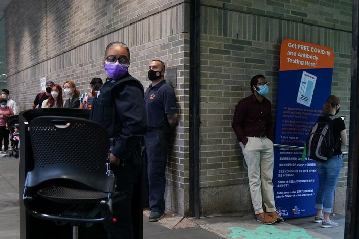 People stand in line for free coronavirus testing this month at Bellevue Hospital in New York City. The daily number of new coronavirus cases reported in the U.S. has remained stubbornly high.