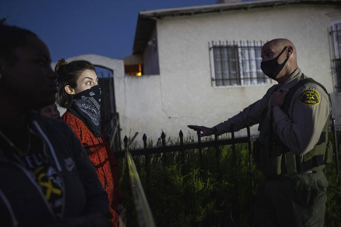 A protester talks with a deputy of the Los Angeles Sheriff's Department during demonstrations following the death of a Black man identified as Dijon Kizzee on Monday in Los Angeles.