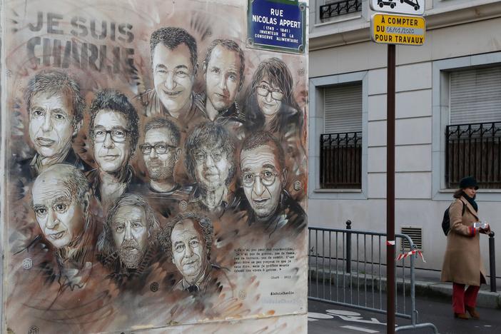 The work of French street artist Christian Guemy aka "C215" depicting members of satirical magazine <em>Charlie Hebdo</em> is painted on a facade near the magazine's offices at Rue Nicolas Appert in Paris, to commemorate the fifth anniversary of the attack of the magazine that killed 12 people.