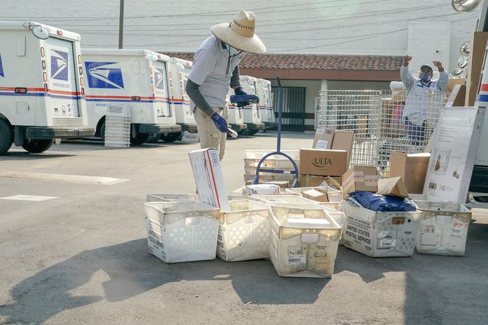 Postal workers sort, load and deliver mail at a U.S. Postal Service location last month in Los Angeles.
