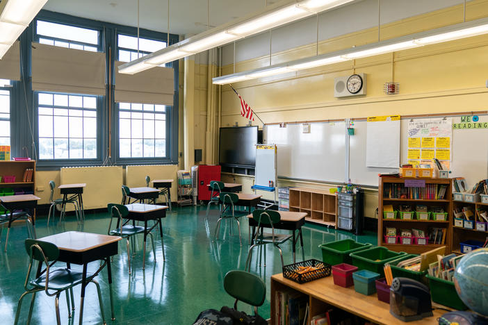 New York public schools are offering two main options to students and their families: "blended" learning, which includes time at schools and remote instruction; or 100% remote learning. Here, students' desks in a public elementary school in Brooklyn are spaced apart for social distancing.