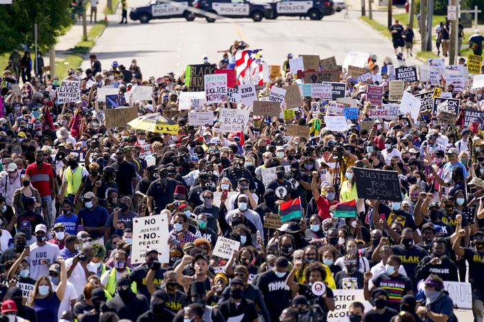Demonstrators march at a rally Saturday for Jacob Blake in Kenosha, Wis. Officials lifted a nightly curfew on Wednesday, saying recent protests had been relatively peaceful.