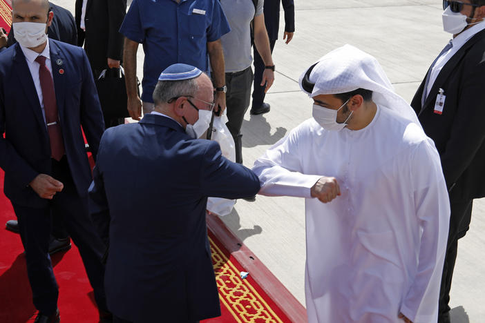 Israeli national security adviser Meir Ben-Shabbat, left, elbow-bumps an Emirati official as he departs Abu Dhabi, United Arab Emirates, Tuesday.