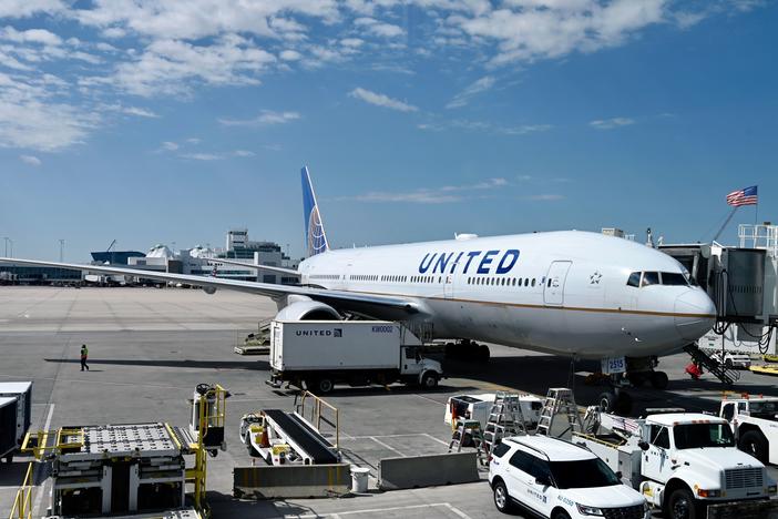A United Airlines plane sits at the gate at Denver International Airport on July 30. The airline industry has been hit hard by the coronavirus pandemic.