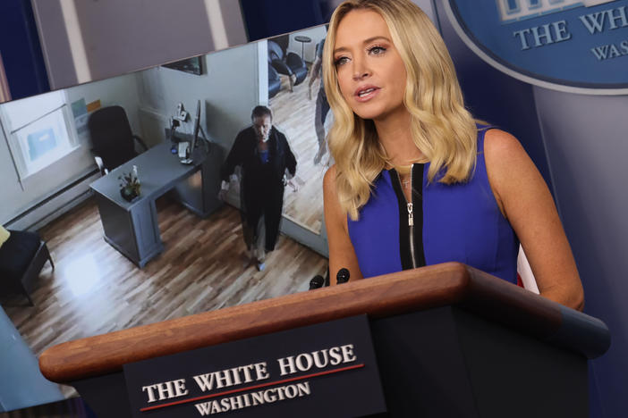 White House press secretary Kayleigh McEnany holds a briefing Thursday as a video of House Speaker Nancy Pelosi entering a San Francisco hair salon plays in the background.