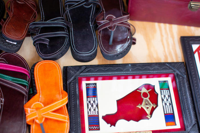 Leather sandals, made by Saley, on display along with other items.