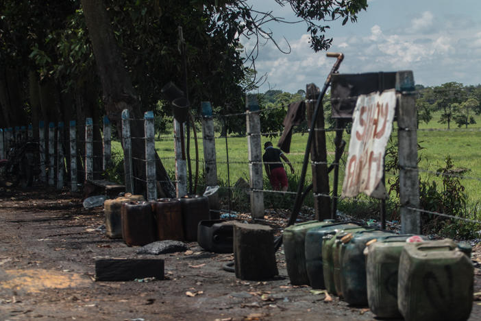 Contraband fuel sits on the side of a road in Puerto Santander, Colombia, on May 31, 2019. The Venezuelan government's lack of cash to import gasoline combined with U.S. sanctions targeting the oil sector have led to chronic fuel shortages in Venezuela. That has upended a long-running, lucrative contraband gas trade.