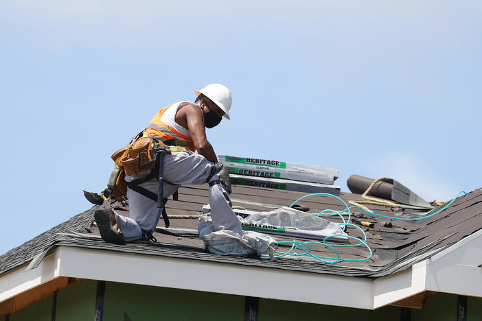 A construction worker roofs an apartment complex in Uniondale, N.Y., on May 27. U.S. employers added fewer jobs last month even as the unemployment rate fell to 8.4%.