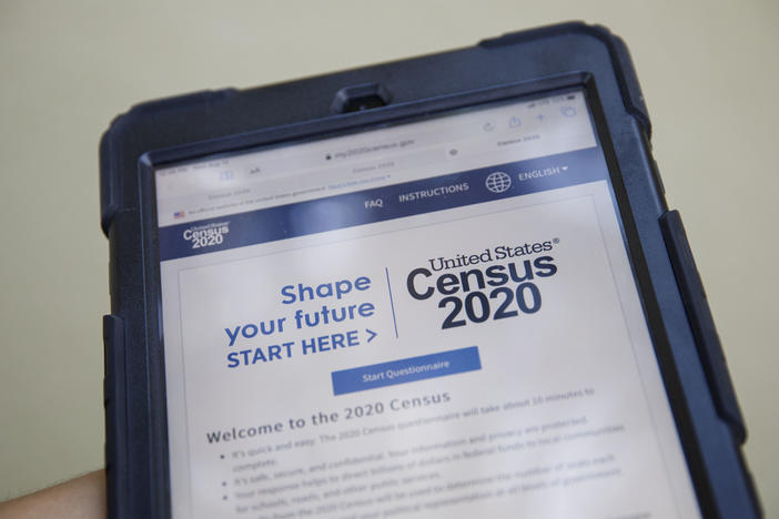 A volunteer in Los Angeles holds a computer tablet displaying the online questionnaire for the 2020 census in August.