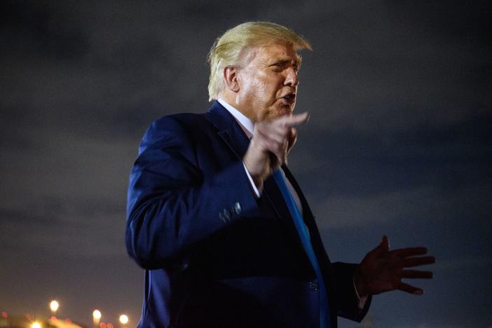 President Trump steps off Air Force One on Friday at Andrews Air Force Base in Maryland. Trump on Friday called <em>The Atlantic</em> article about his attitudes toward the military "a total lie," and he was backed up by some White House officials.