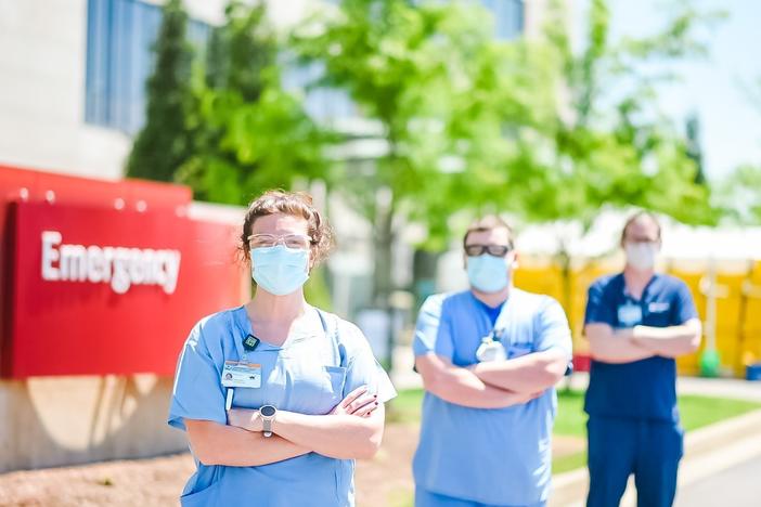 A triage team screens patients outside the Emergency Department at Owensboro Health. The hospital lost two-thirds of its revenue while elective surgeries were halted, but it didn't lay off any workers.