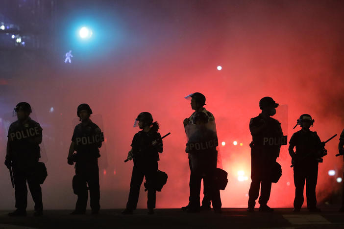 Police hold a perimeter near the White House as demonstrators gather to protest police brutality in the morning hours of May 31 in Washington, D.C.