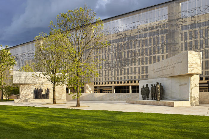 The Dwight D. Eisenhower Memorial in Washington, D.C., will be dedicated on Thursday. A stainless steel, woven "tapestry" made by artist Tomas Osinski stands behind the statues and depicts the cliffs at Normandy.