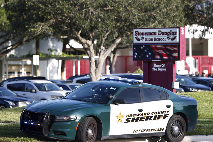 A Broward County Sheriff's Office vehicle is parked outside Marjory Stoneman Douglas High School, in Parkland, Fla.