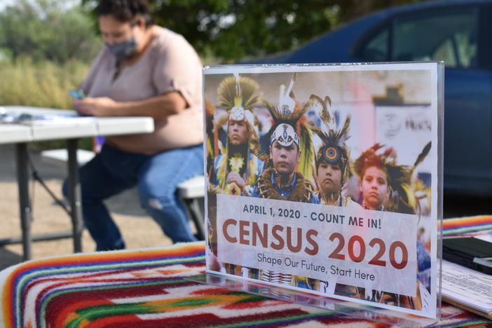 A sign promoting participation in the 2020 census is displayed as Selena Rides Horse enters information into a phone for a member of the Crow Indian Tribe in Lodge Grass, Mont., in August.