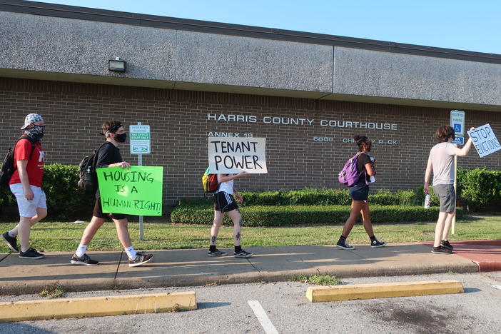 Protesters march Aug. 21 outside a courthouse in Houston, where evictions are continuing despite a moratorium ordered recently by the Centers for Disease Control and Prevention.