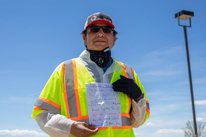 Navajo Nation President Jonathan Nez holds a letter from a Navajo family while distributing food, water and other supplies on May 27, on the Navajo Nation Reservation in New Mexico.