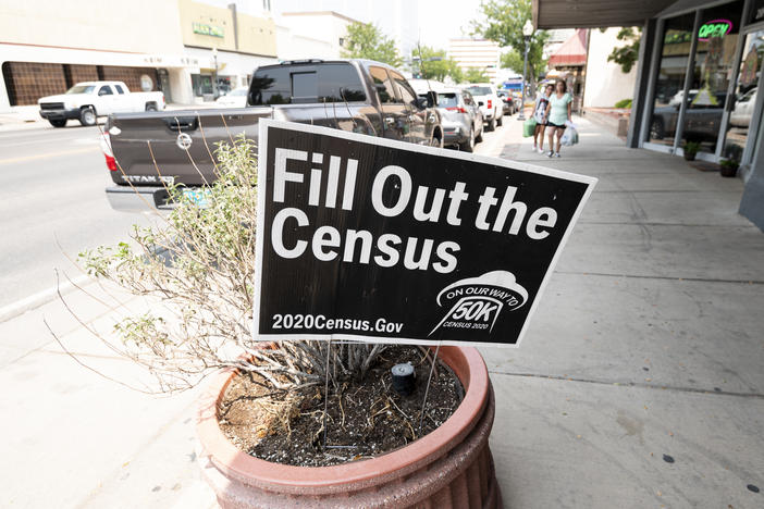 A sign promoting the 2020 census stands in a planter in Roswell, N.M., in August. A federal judge has ordered the Trump administration to continue holding off on wrapping up the census for now.