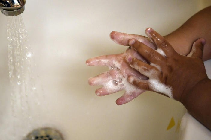 A child washes her hands at a day care center in Connecticut last month. A detailed look at COVID-19 deaths in U.S. kids and young adults by the Centers for Disease Control and Prevention shows the great majority are children of color.