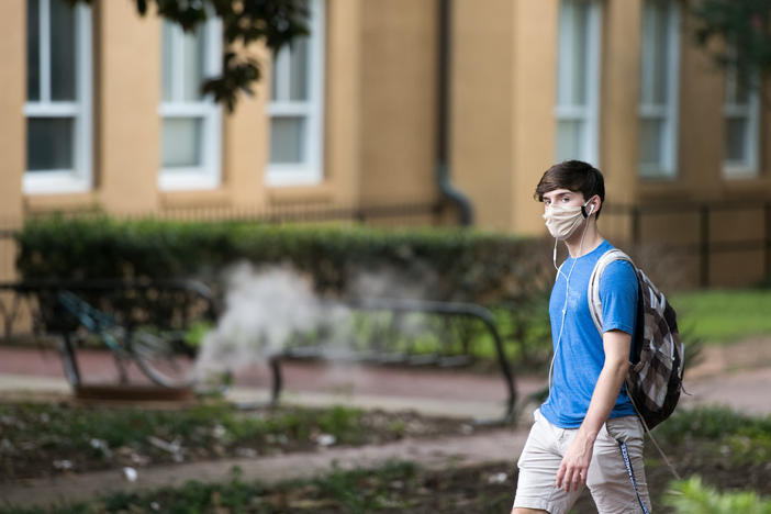 A student walks on campus at the University of South Carolina. During the final week of August, the university reported a 26.6% positivity rate among the student population tested for the coronavirus.
