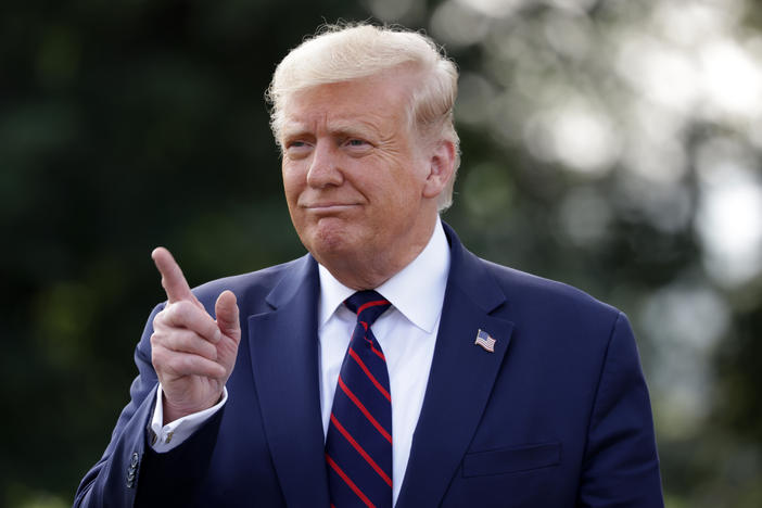 President Trump speaks to members of the press at the White House on Tuesday. On Wednesday, Trump praised the Big Ten's decision to resume the college football season at the end of October.