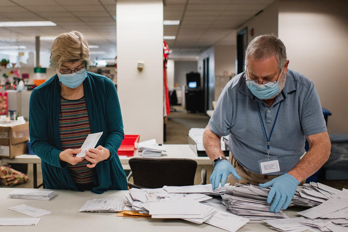 Andrea Lerner (left), and her husband, Ira Lerner, sift through the mail-in applications at the Voter Registration office in the Lehigh County Government Center in Allentown, Pa.